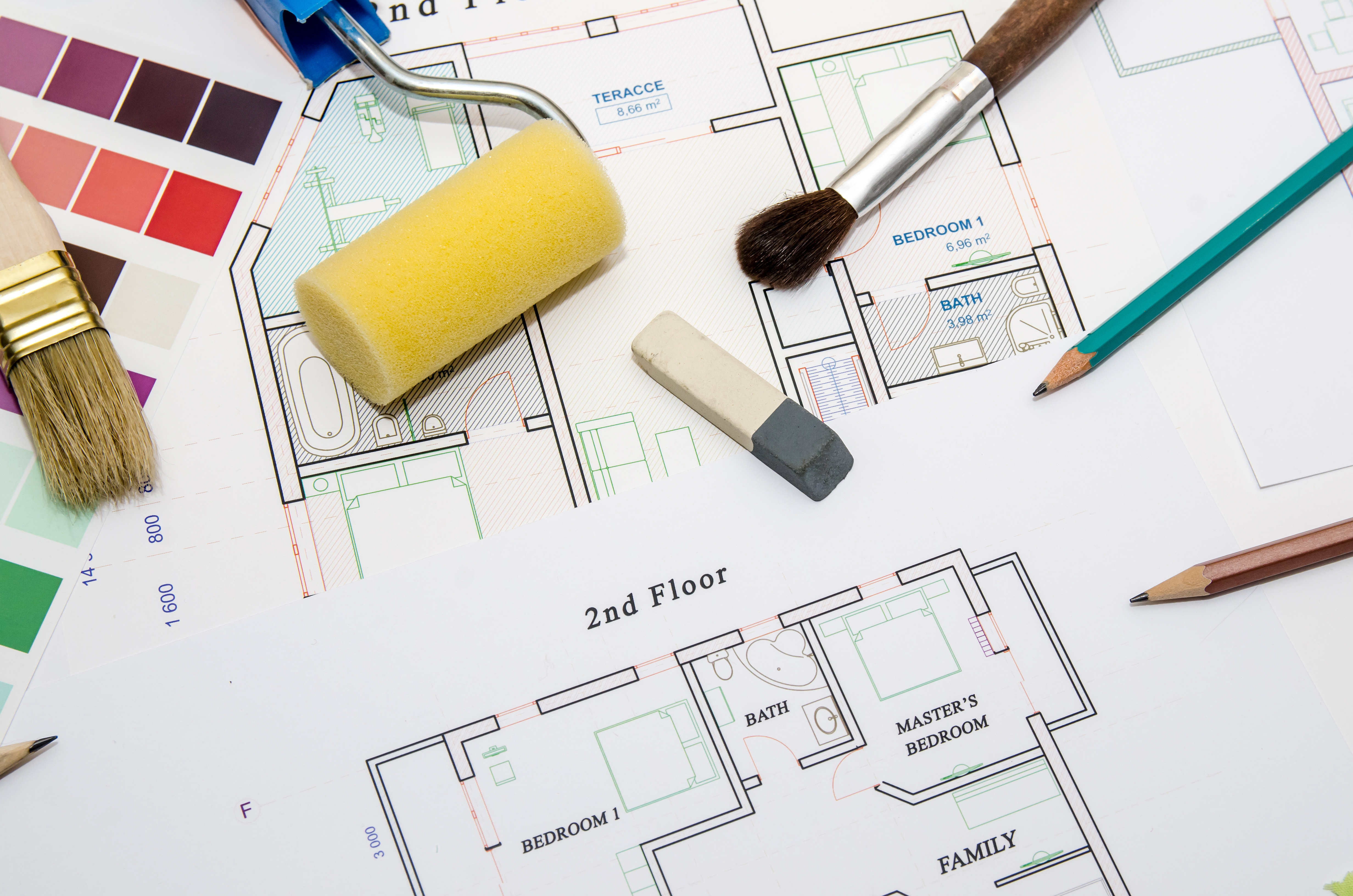 architectural drawing with paintbrush, color sample and working tools